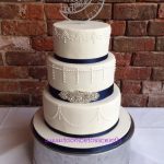 White & navy wedding cake with diamante 