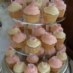 Cup cakes with cream cheese frosting topped with sugar rose petal or butterfly Â